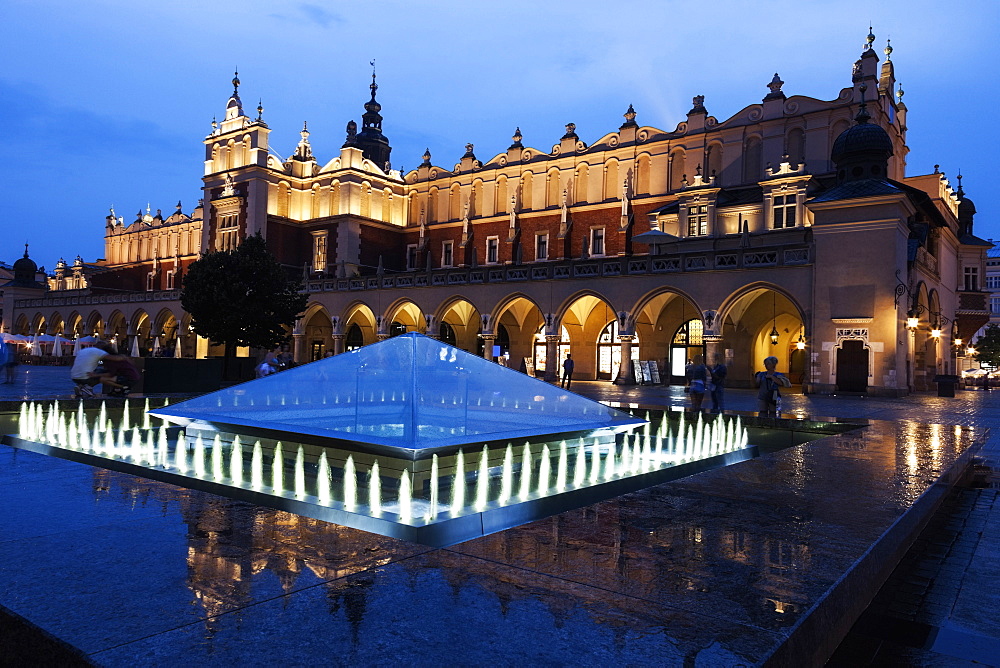 Fountain and Cloth Hall evening time, Krakow, Poland 