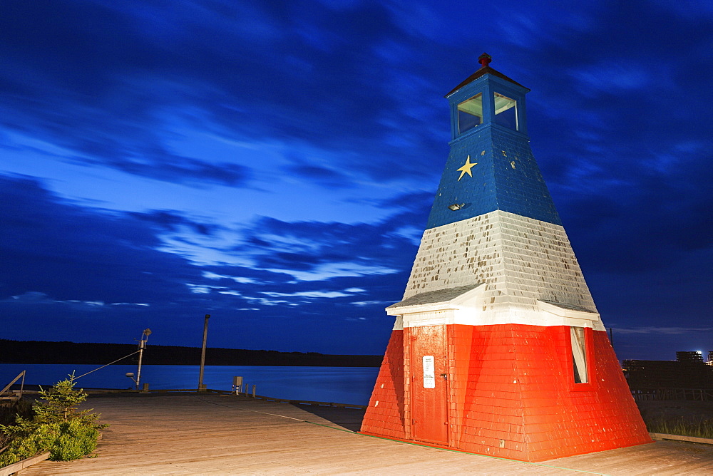 Lighthouse in harbor at dusk, Nova Scotia, Canada