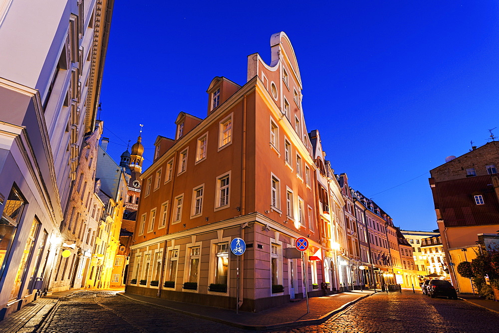 Corner of illuminated building against blue dusk sky, Latvia