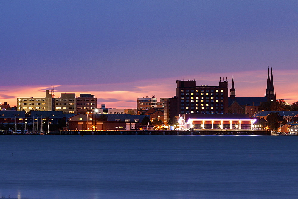 Illuminated waterfront skyline against moody sky, Prince Edward Island, New Brunswick, Canada