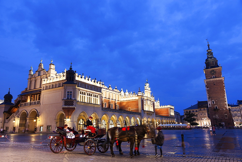 Horse cart against Cloth Hall on main square, Poland