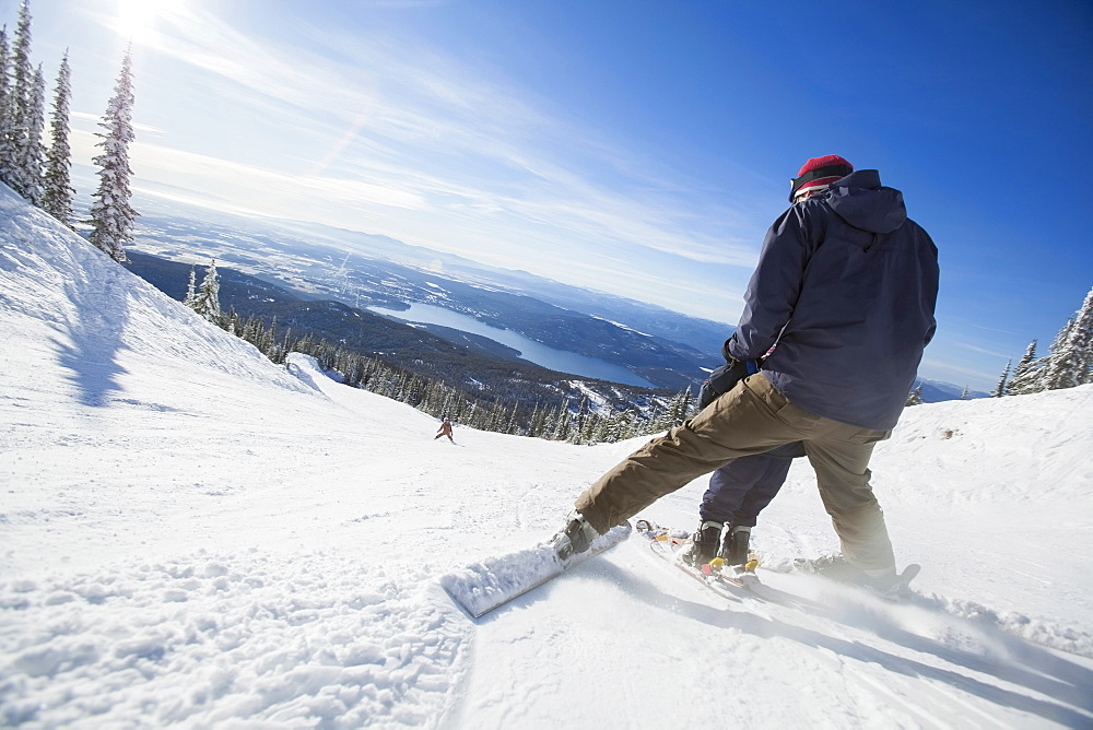 Father skiing with son (6-7), Whitefish, Montana, USA
