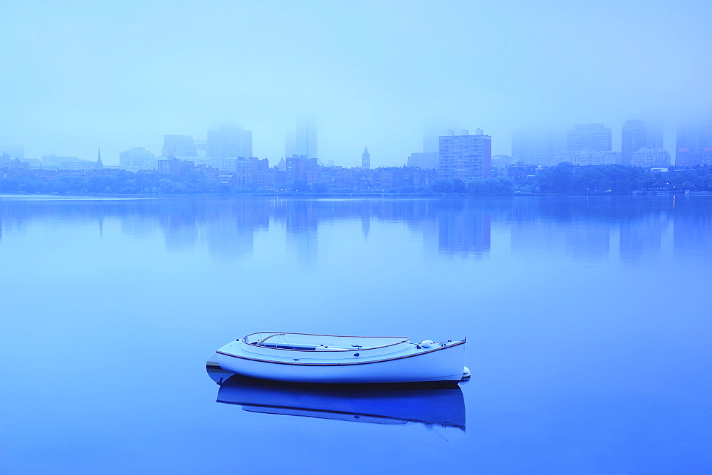 Lone boat on Charles river on foggy morning, Massachusetts