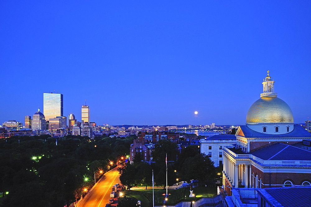 View of Massachusetts State House Dome and city skyline at moonrise, Boston, Massachusetts