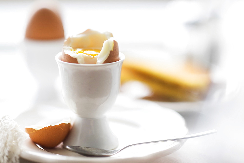 Close up of soft boiled egg in egg cup