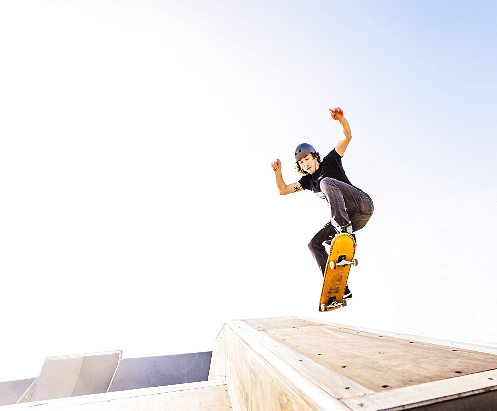 Man jumping on skateboard in skatepark, West Palm Beach, Florida