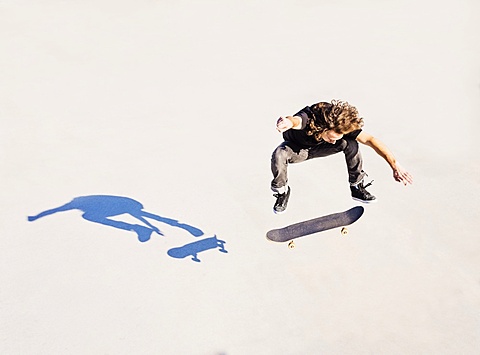 Man jumping on skateboard in skatepark, West Palm Beach, Florida