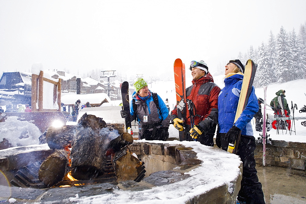 Group of friends with bonfire in winter, Whitefish, Montana, USA