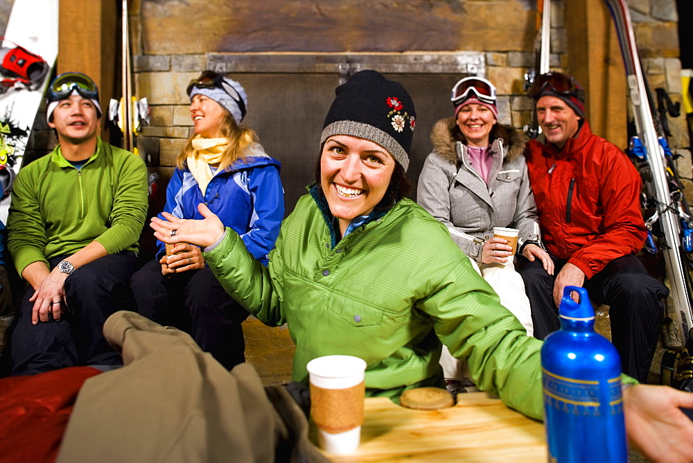 Group of skiers hanging out at fireplace, Whitefish, Montana, USA