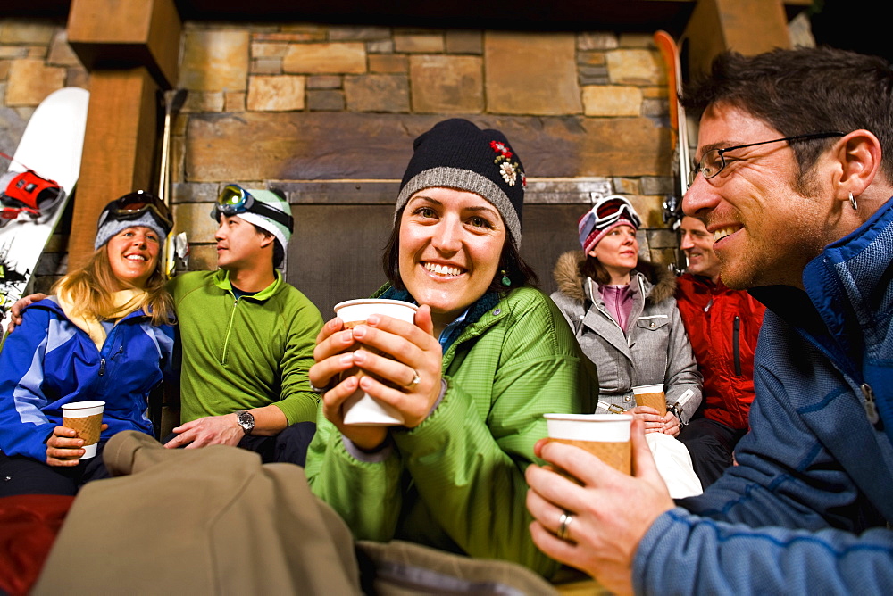 Group of skiers hanging out at fireplace, Whitefish, Montana, USA