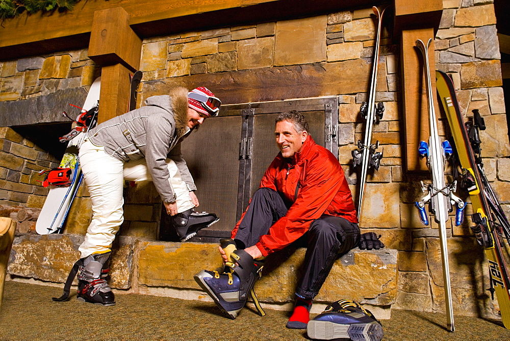 Skier putting on ski boots, Whitefish, Montana, USA