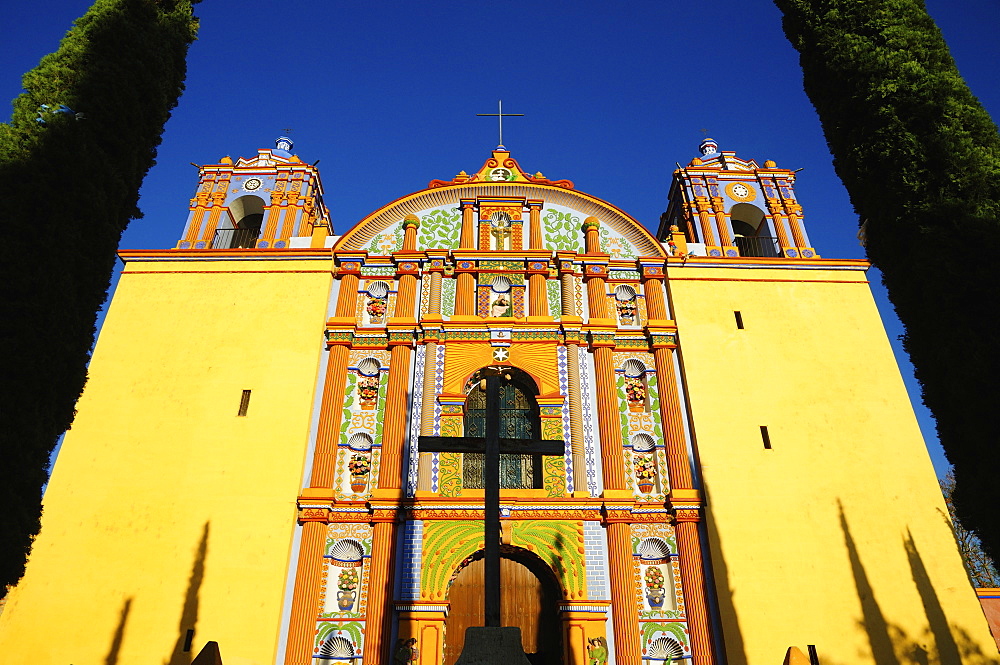 Low angle view of yellow ornate church, Santa Ana Zegache, Oaxaca, Mexico