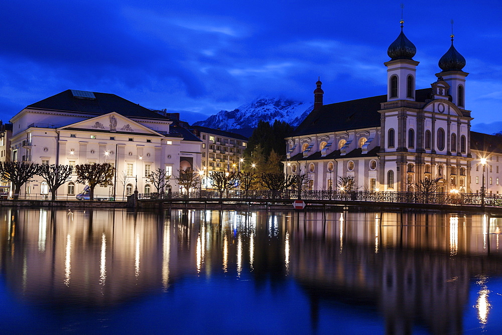 Illuminated building reflecting in lake, Lucerne, Switzerland