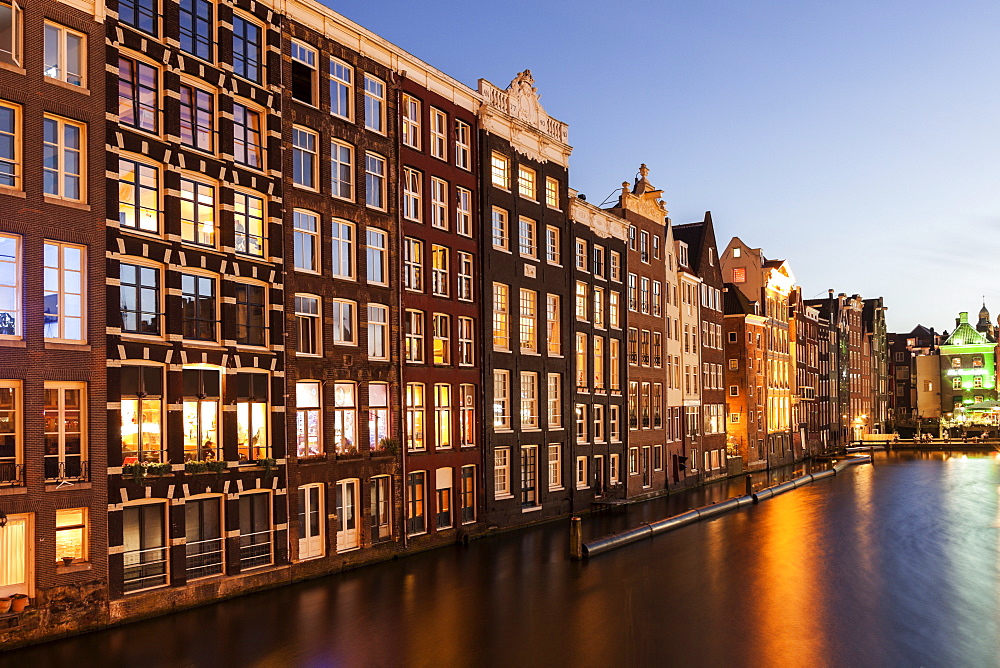 Buildings by canal at sunrise, Amsterdam, North Holland, Netherlands