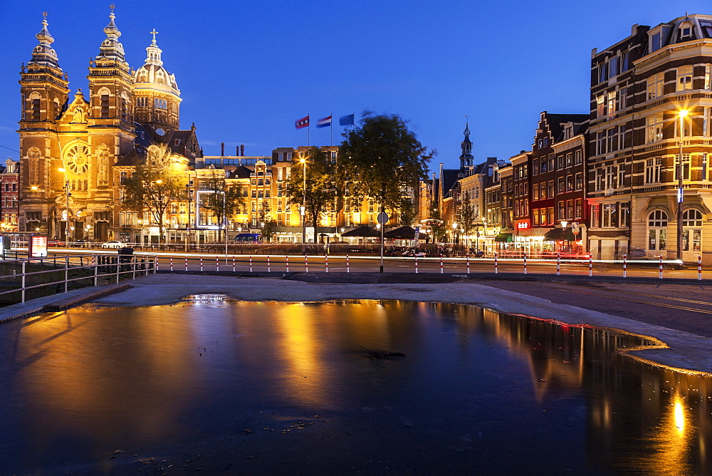 Canal and illuminated buildings at sunrise, Amsterdam, North Holland, Netherlands