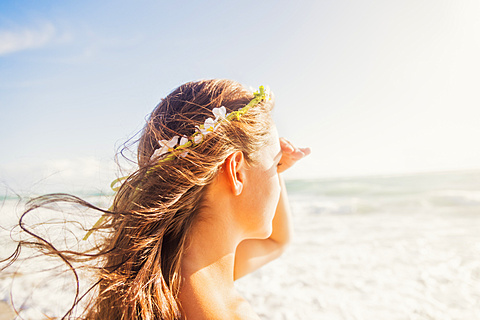 Woman on beach shielding eyes, Jupiter, Florida,USA