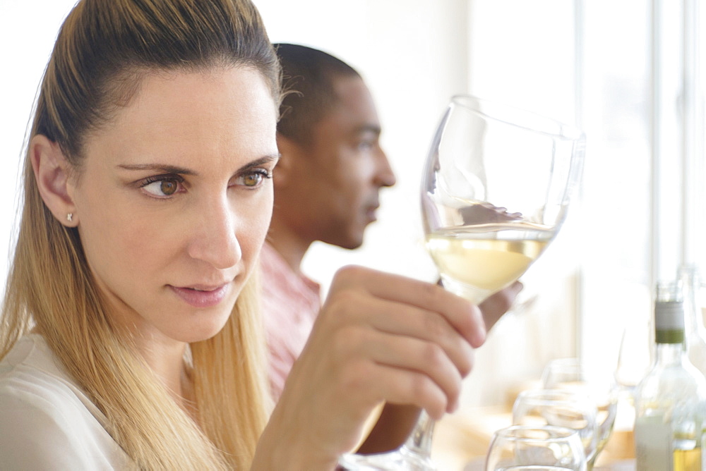 Man and woman tasting white wine