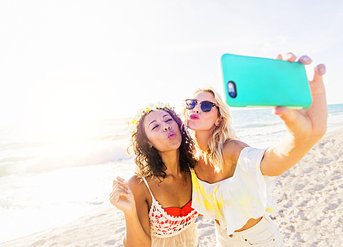 Female friends taking selfie on beach, USA, Florida, Jupiter