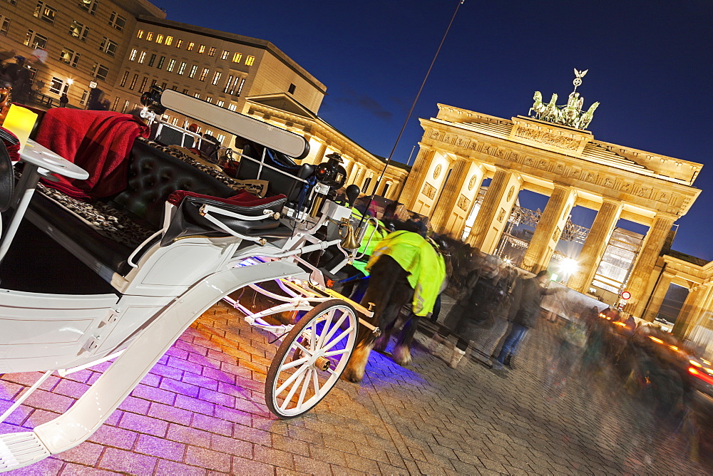 Horse carts in front of illuminated Brandenburg Gate, Germany, Berlin, Carriages on Pariser Platz, Brandenburg Gate