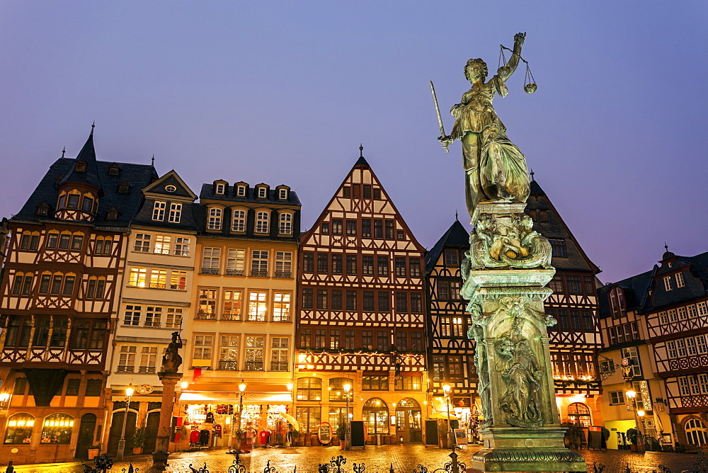 Statue on illuminated square, Germany, Hesse, Frankfurt, Romerberg Plaza