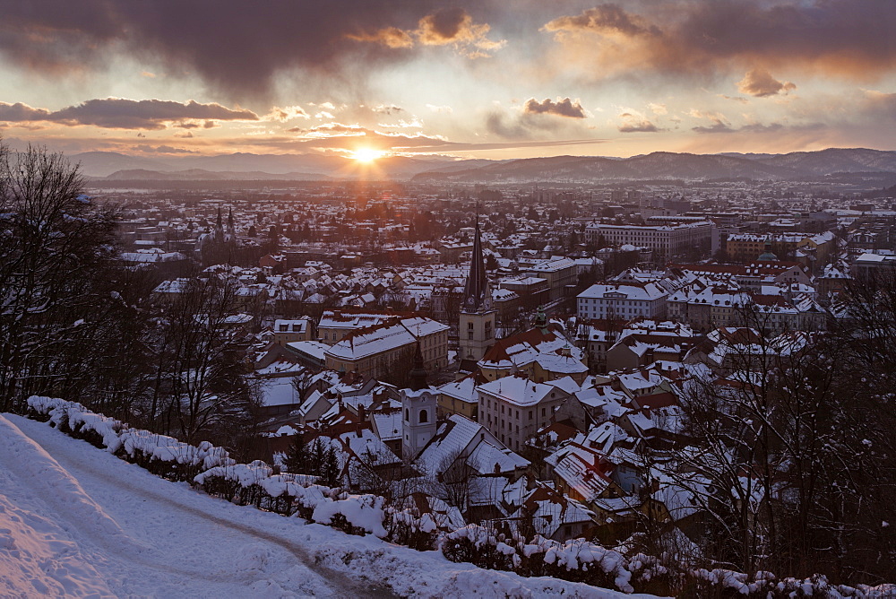 Winter cityscape at sunrise, Slovenia, Ljubljana, St. Florian's Church, St. James's Parish Church