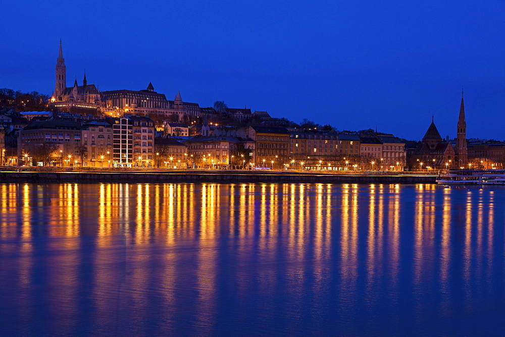 Illuminated skyline reflecting in Danube River, Hungary, Budapest, Matthias Church,Fisherman's Bastion, Danube River