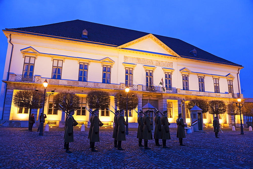 Honor guard in front of illuminated Sandor Palace, Hungary, Budapest, Sandor Palace