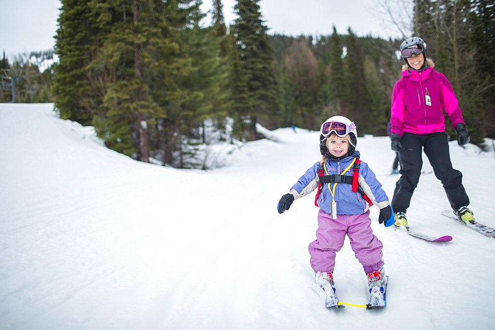 Little girl (2-3) learning skiing with mother, USA, Montana, Whitefish