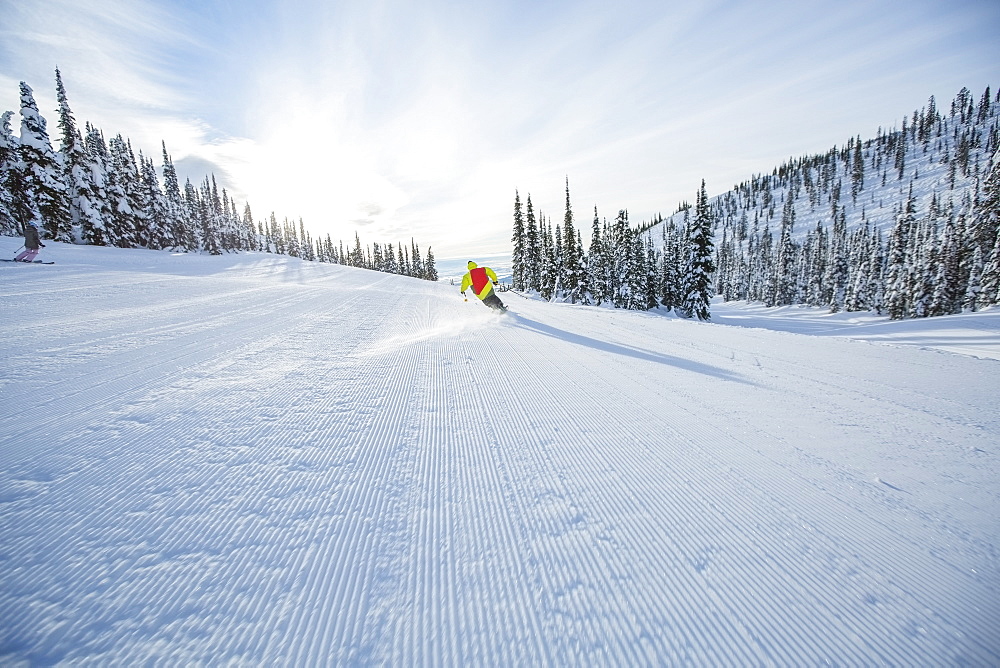 Young man speeding on ski slope, USA, Montana, Whitefish