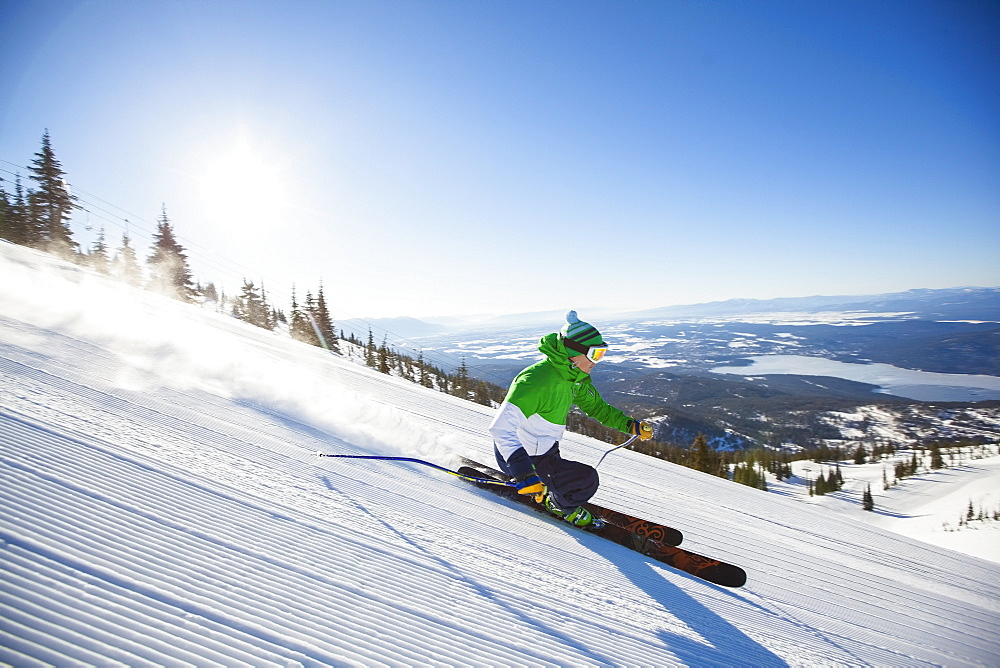 Mature man on ski slope at sunlight, USA, Montana, Whitefish