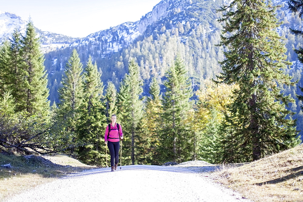 Austria, Salzburger Land, Weissbach, Mature woman hiking on sunny day in mountain landscape