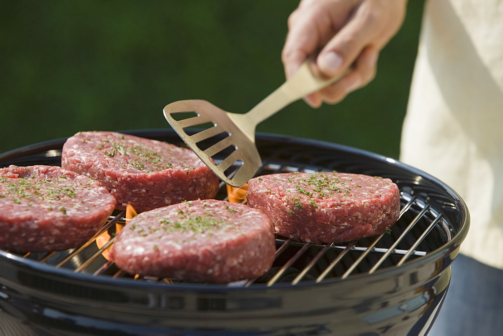 Close up of hamburgers on barbecue grill