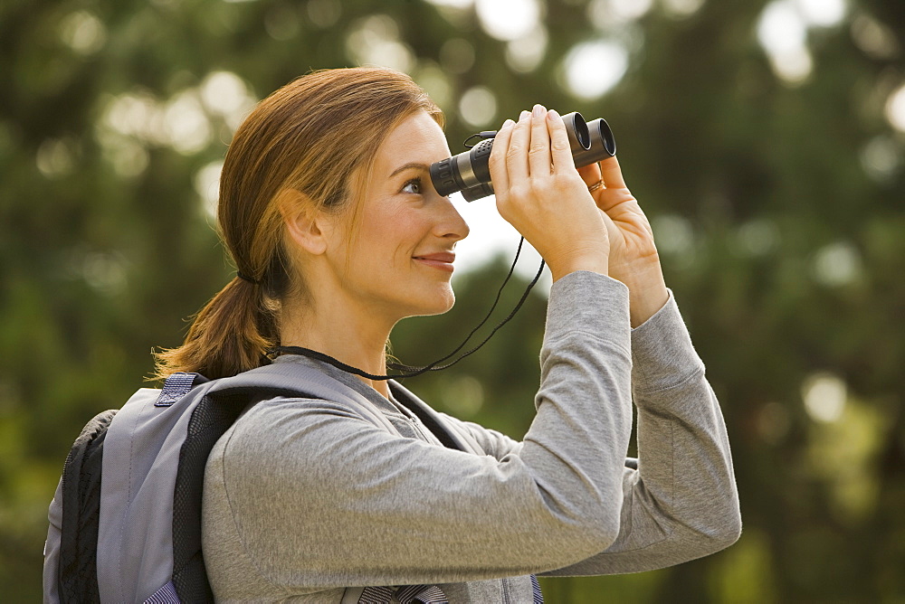 Woman looking through binoculars