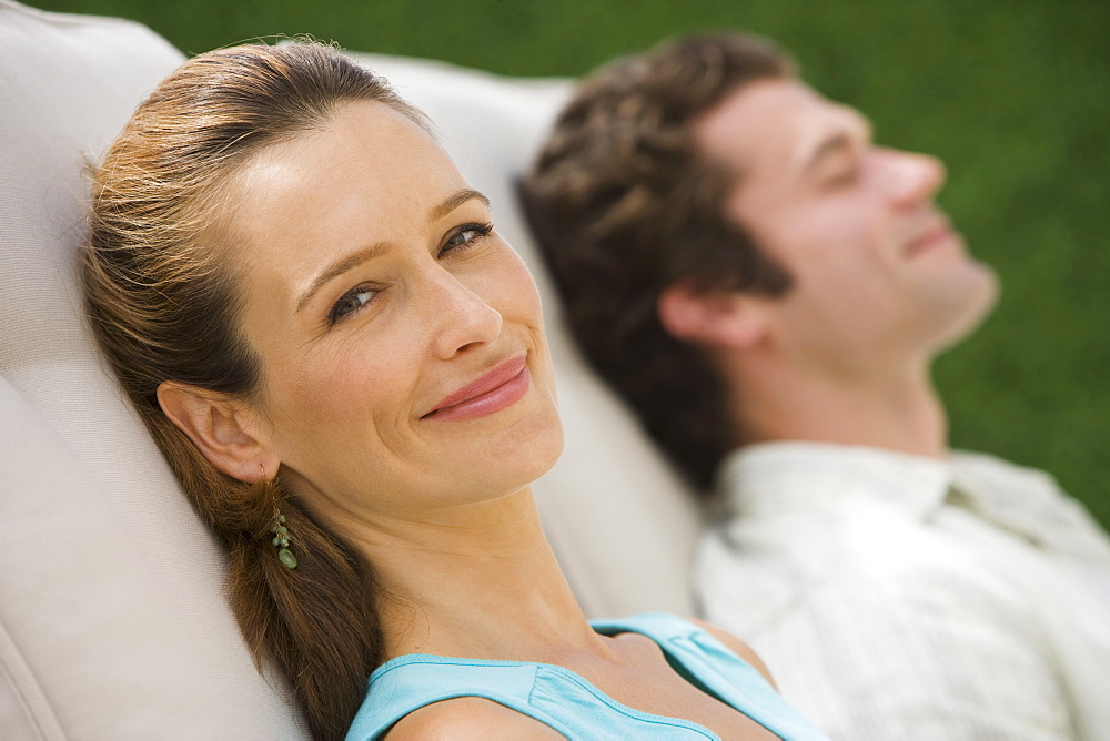 Couple laying in lounge chairs