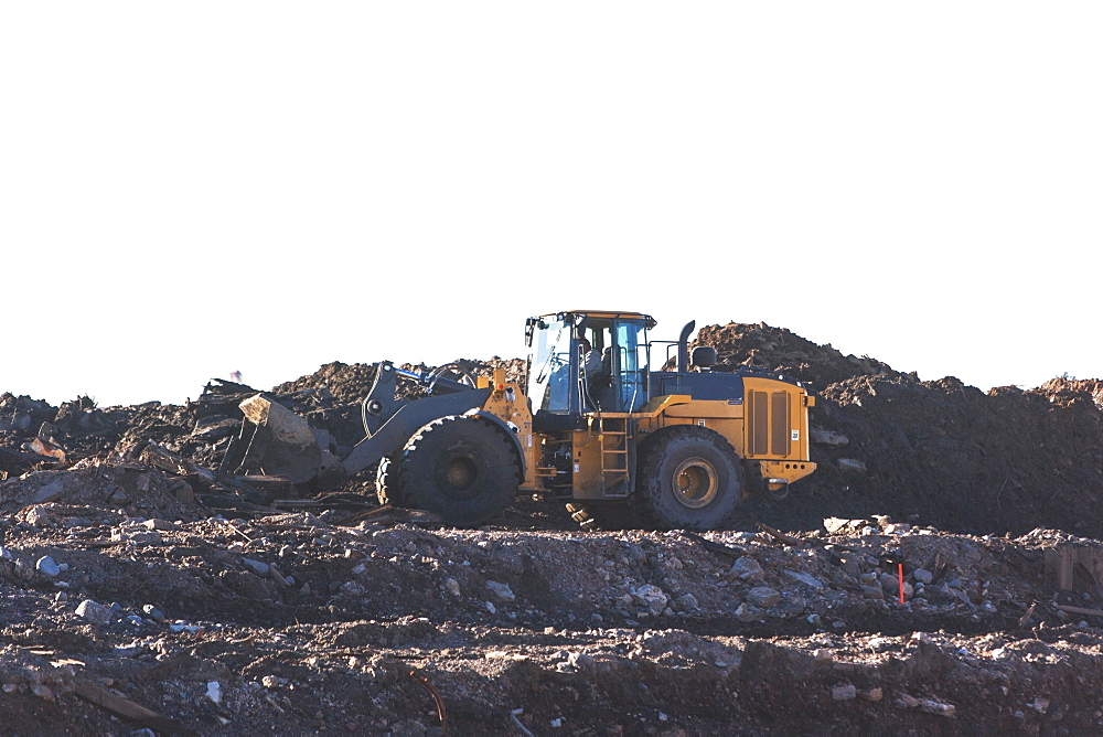 USA, New York State, New York City, Bulldozer on garbage dump