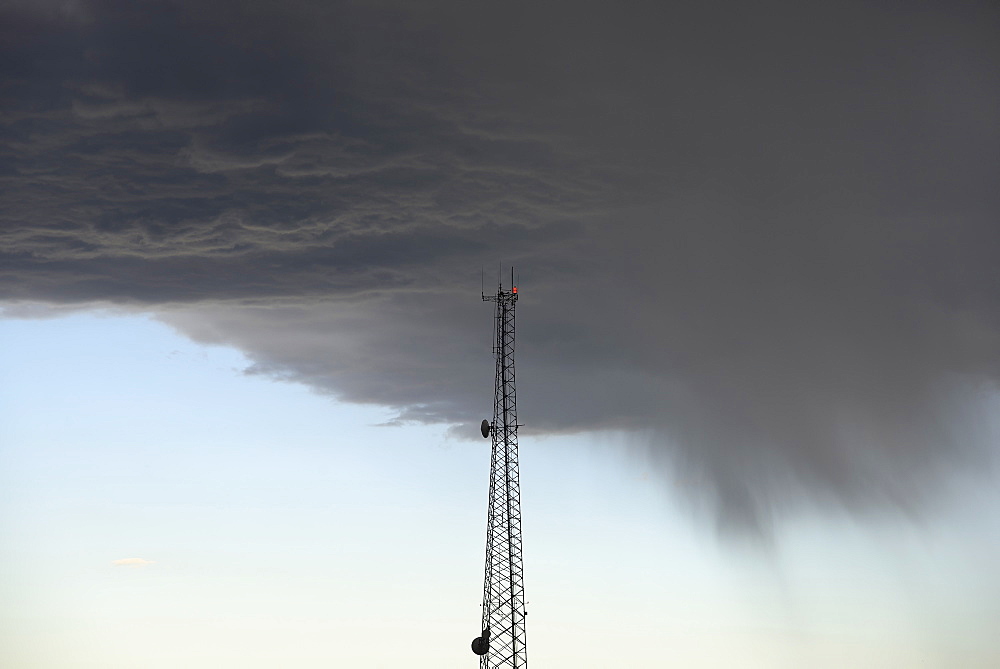 Storm clouds gathering above communications tower