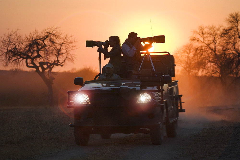 Photographers riding on all terrain vehicle 