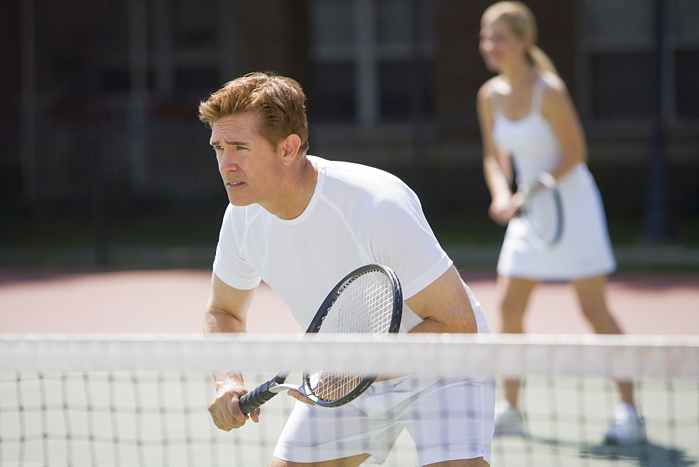 Couple playing tennis