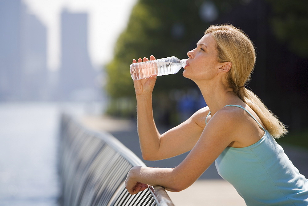 Woman drinking from water bottle
