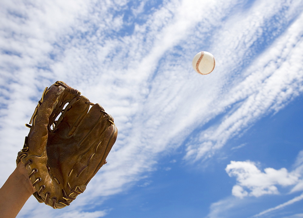 Hand in baseball glove catching ball