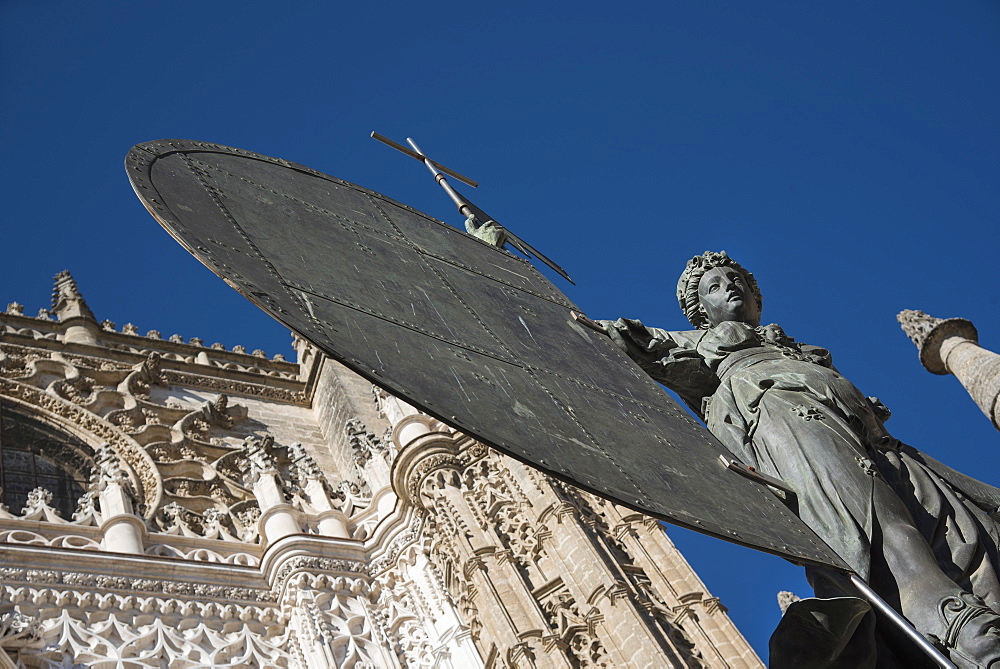 Spain, Seville, Facade of Cathedral of Seville with statue