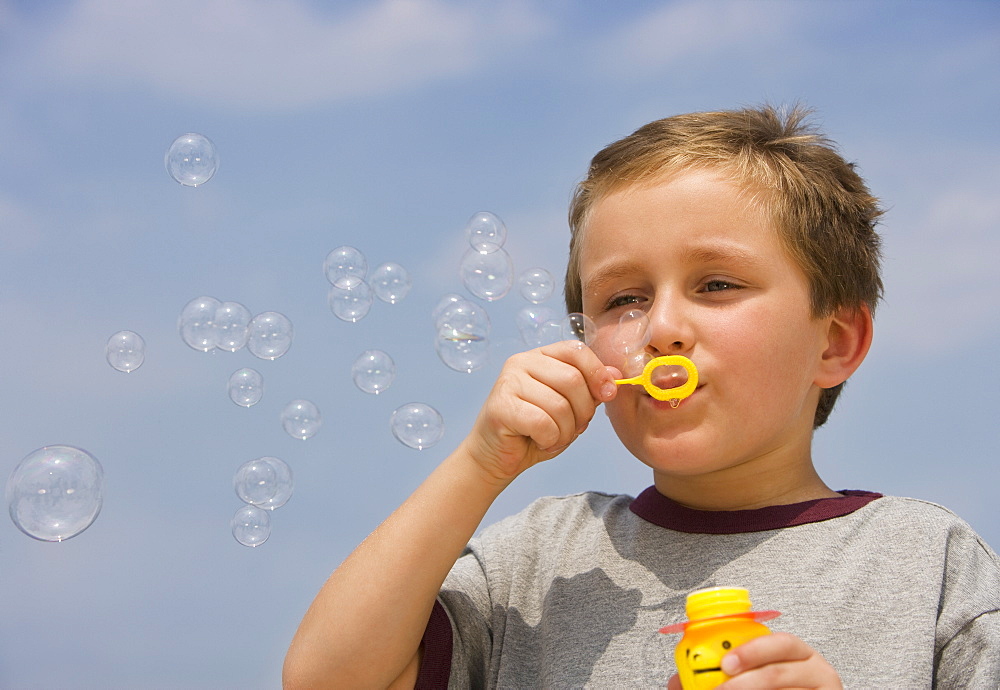 Boy blowing bubbles