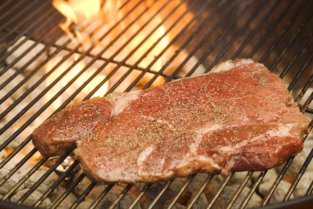 Steak cooking on grill