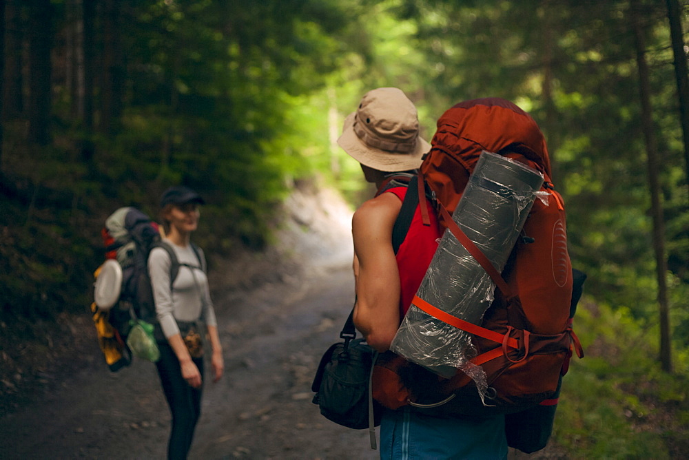 Couple hiking in forest at the Carpathian Mountain Range, Ukraine