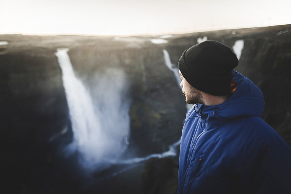 Hiker by Haifoss waterfall in Iceland