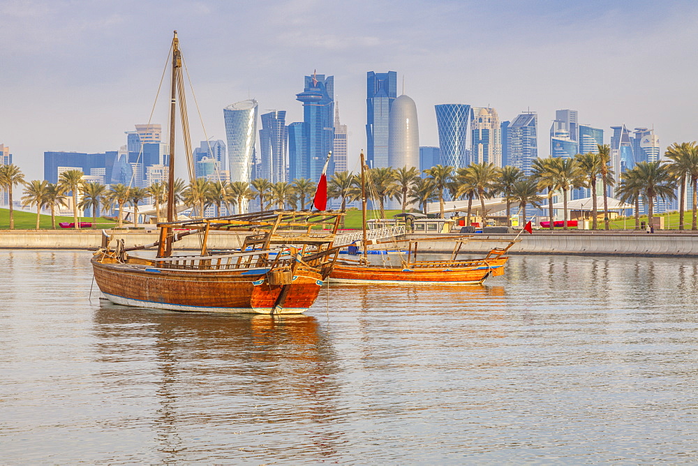 Boats by skyscraper skyline in Doha, Qatar