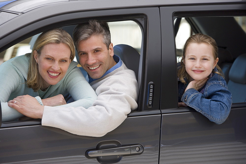 Family smiling in car