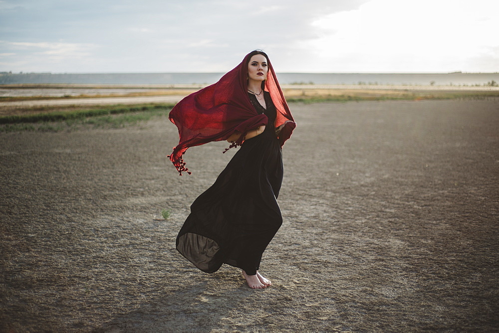 Windswept woman wearing red headscarf