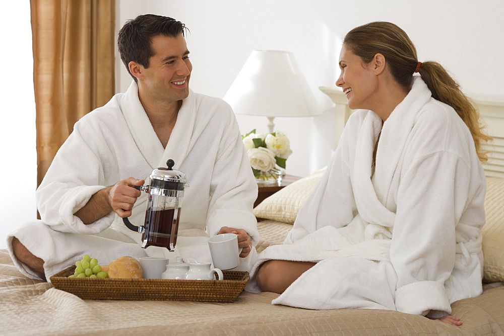 Couple eating breakfast in bed