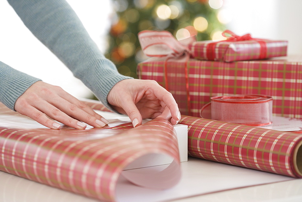 Woman wrapping Christmas gifts